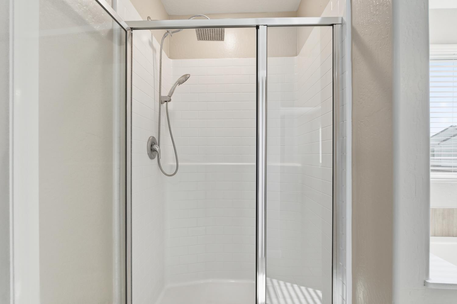 1107 Significant Way West Madera, CA 93636 - Photo 28 of 42 a bathroom with a glass shower door