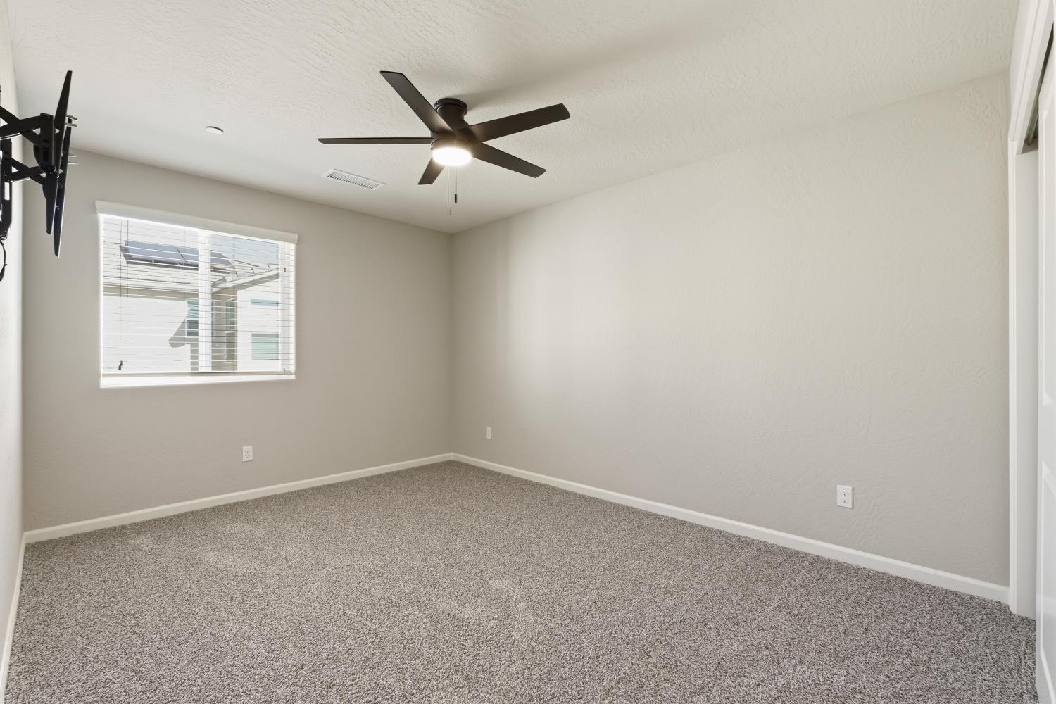 1107 Significant Way West Madera, CA 93636 - Photo 29 of 42 an empty room with windows and fan