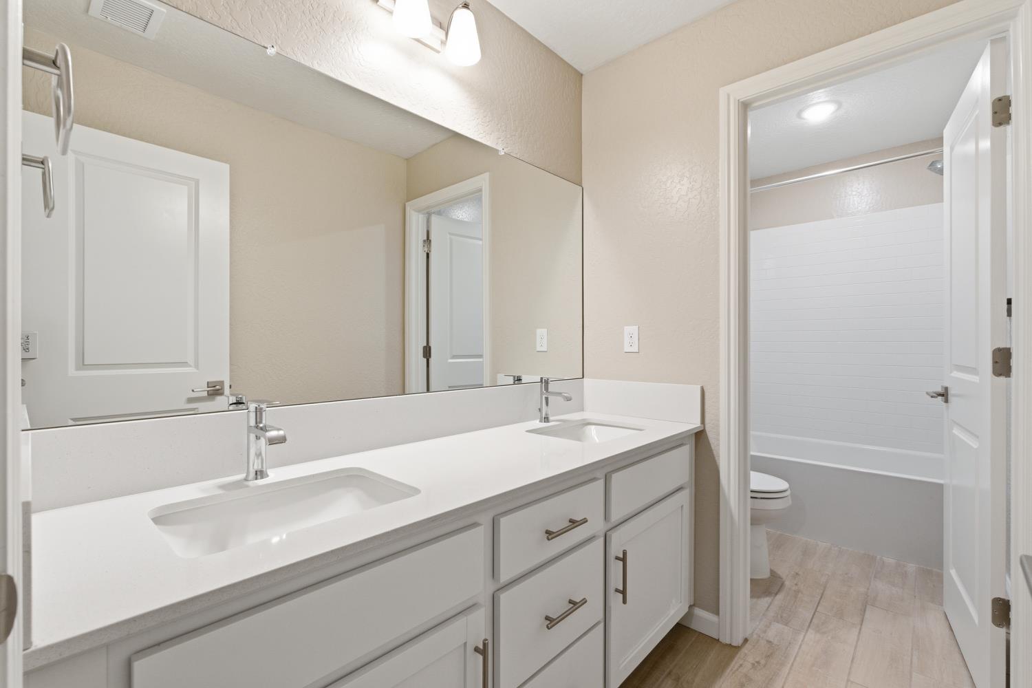 1107 Significant Way West Madera, CA 93636 - Photo 30 of 42 a bathroom with a sink a toilet and shower