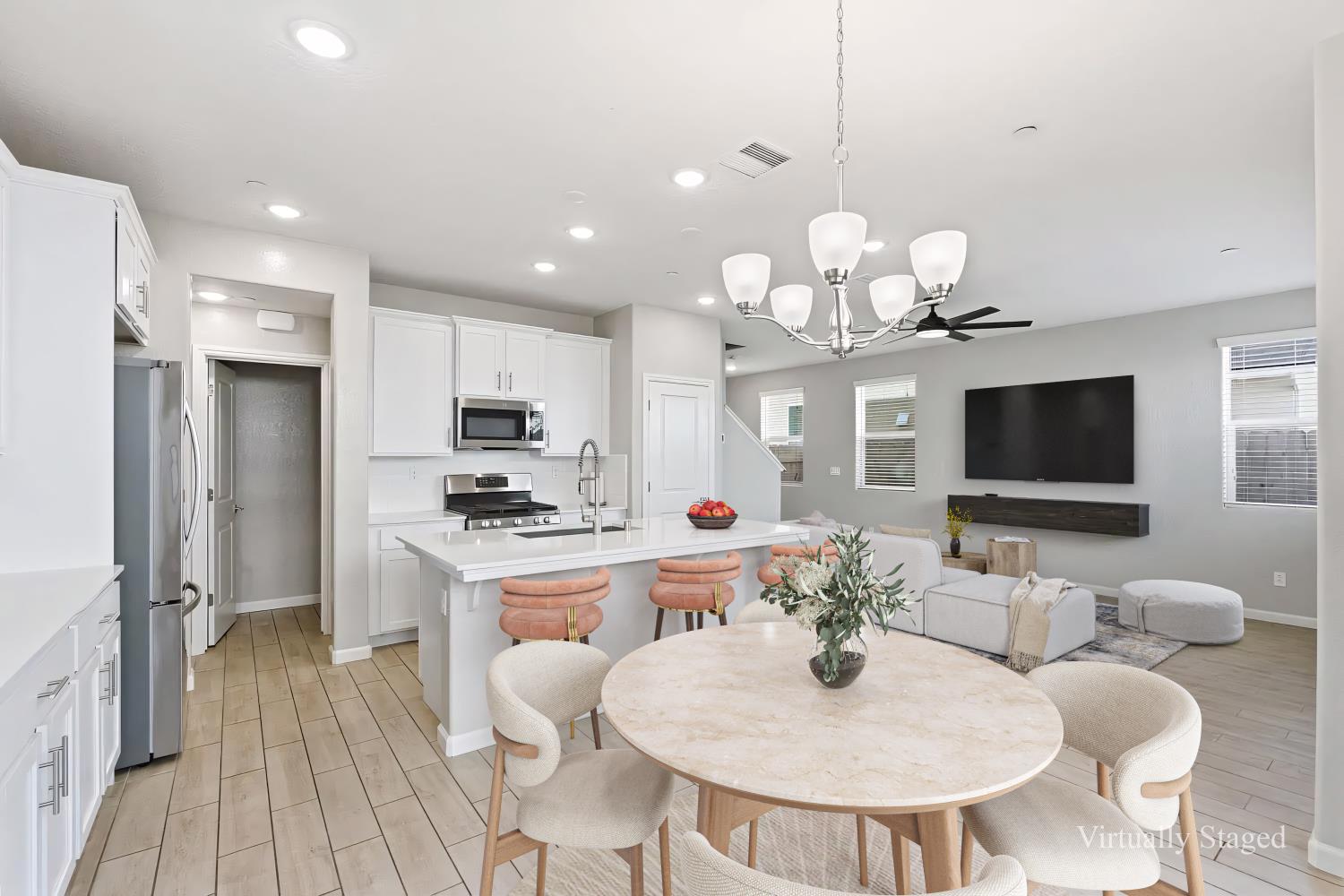 1107 Significant Way West Madera, CA 93636 - Photo 3 of 42 a kitchen with kitchen island granite countertop a stove a oven a dining table and chairs with wooden floor