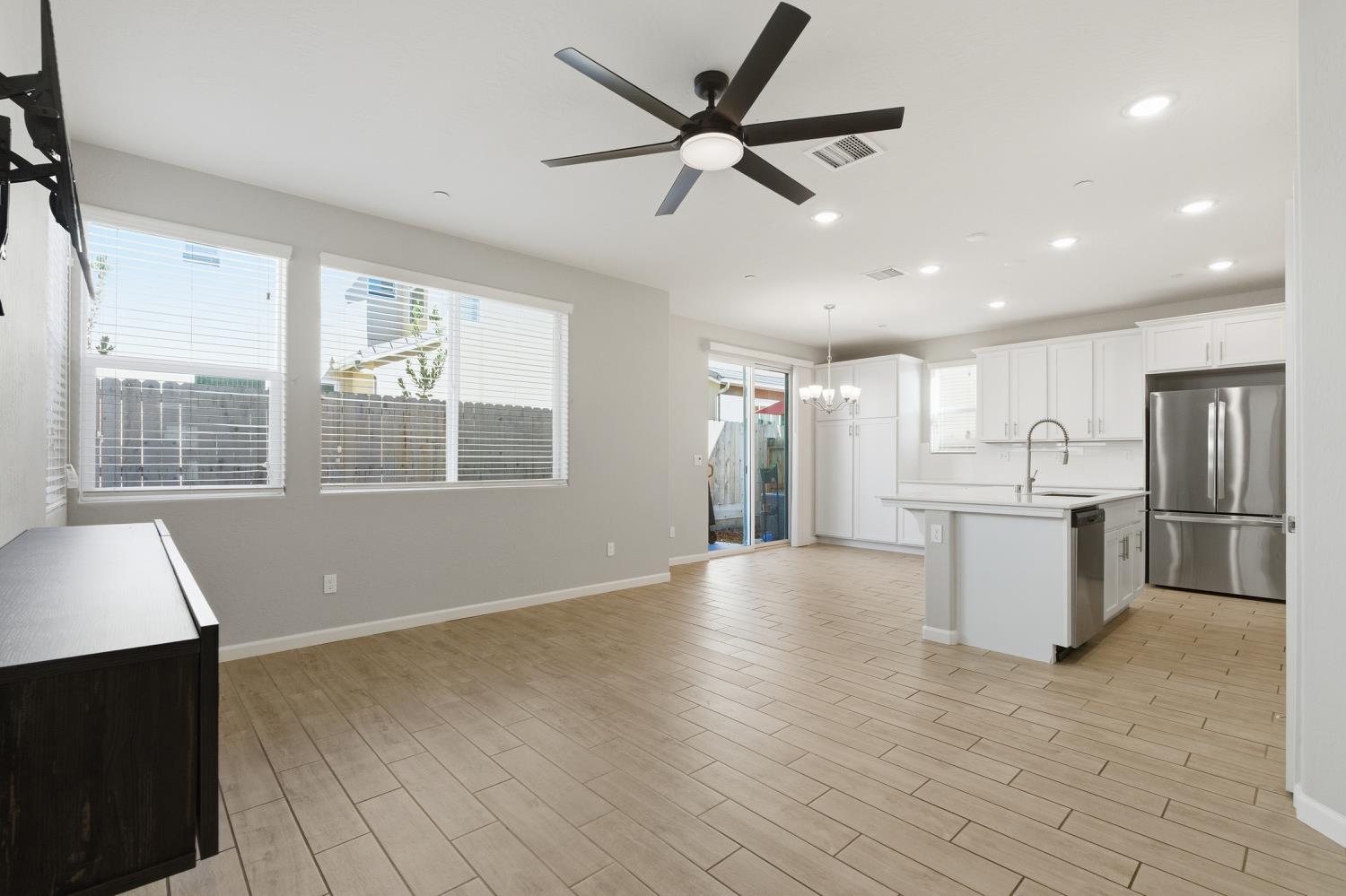 1107 Significant Way West Madera, CA 93636 - Photo 10 of 42 a view of an empty room with a window and kitchen