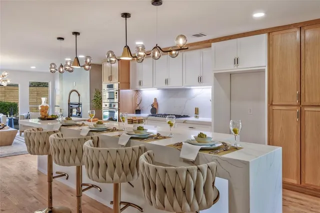 a kitchen with a table chairs stove and cabinets