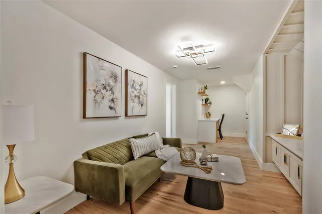 a living room with furniture and kitchen view