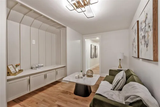 a living room with furniture and a chandelier