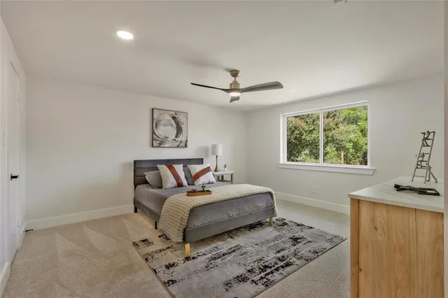 a bathroom with a granite countertop sink mirror and bathtub