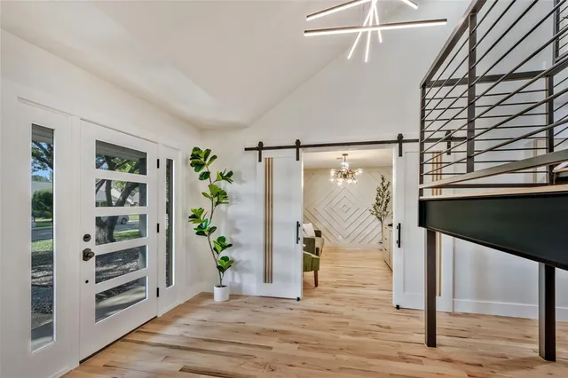 a large kitchen with kitchen island a large counter space a sink appliances and cabinets