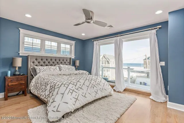 a bedroom with a large bed and a large window