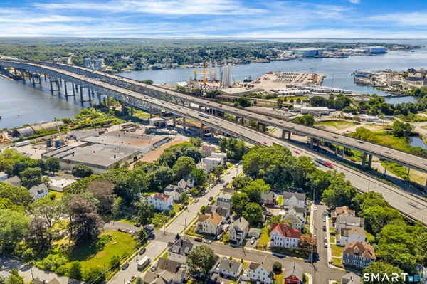 an aerial view of a house with a yard and lake view
