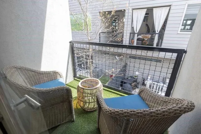 a living room with furniture kitchen and a potted plant