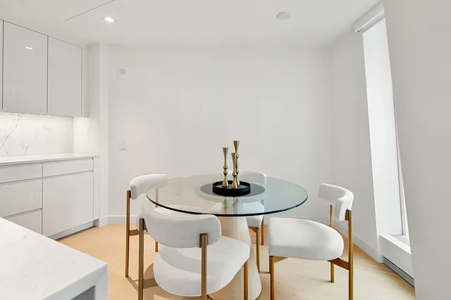 a living room with furniture and kitchen view