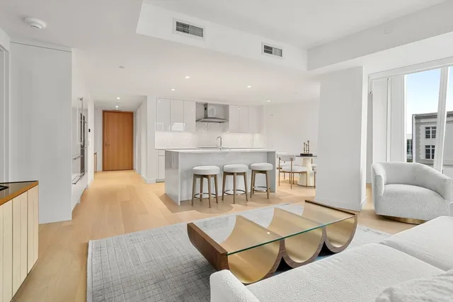 a large bedroom with a bed and a large window