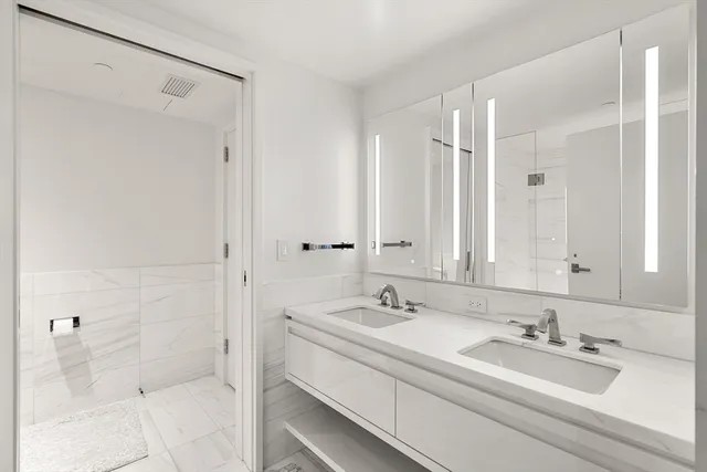 a bathroom with a shower and a sink