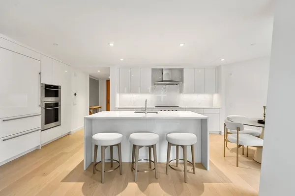 a white stove top oven sitting inside of a kitchen