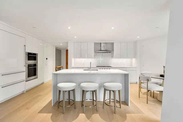 a white stove top oven sitting inside of a kitchen