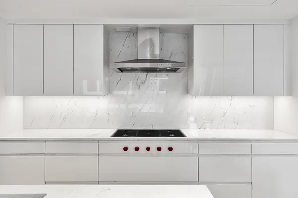 a kitchen with stainless steel appliances a stove a sink and a refrigerator