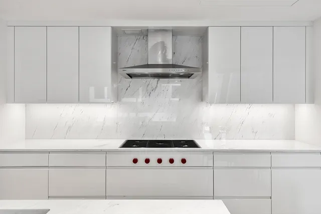 a kitchen with stainless steel appliances a stove a sink and a refrigerator