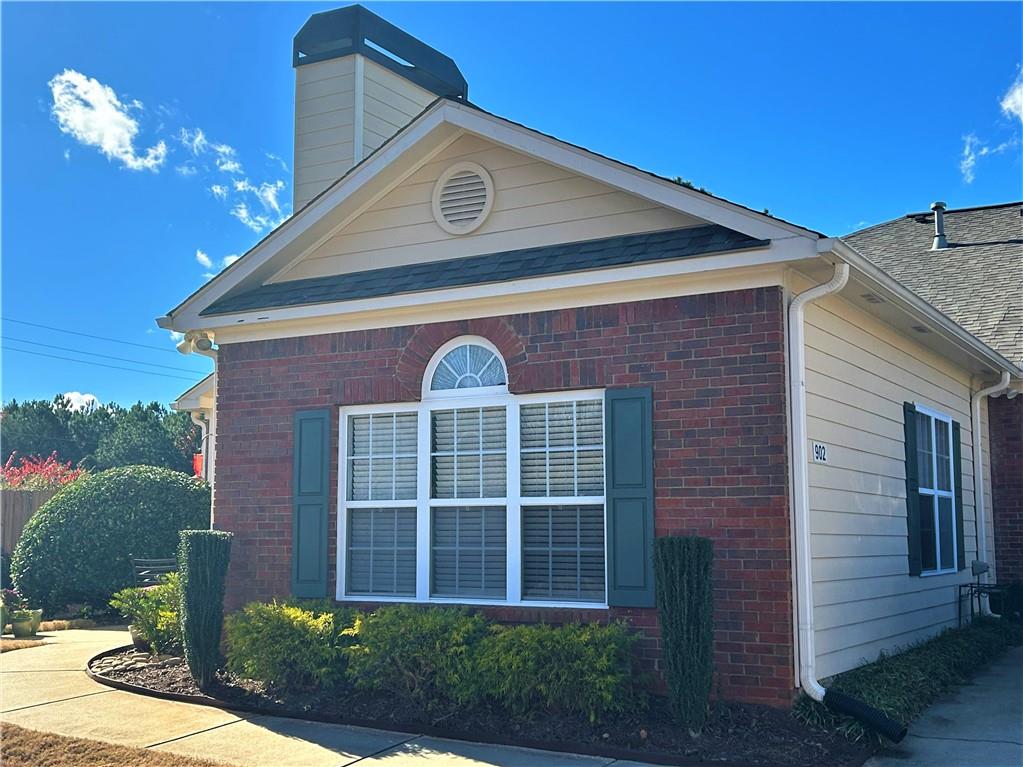 460 Tribble Gap Road, Unit 902 Cumming, GA 30040 - Photo 1 of 1 a front view of a house with a yard