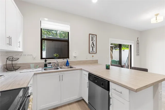 a view with a sink cabinets and a wooden floor