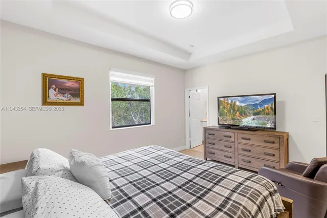 a bedroom with a bed and dresser