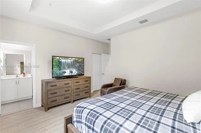 a bedroom with a bed and a television