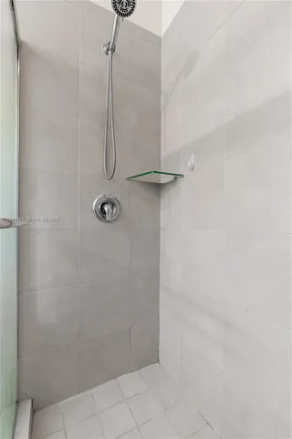 a bathroom with a glass shower door