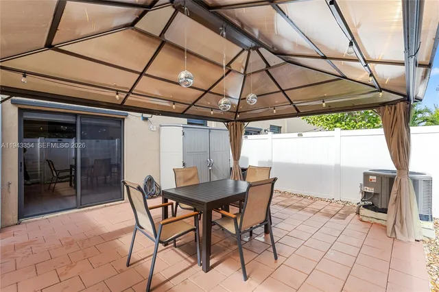 a view of an outdoor space with a table and chairs in patio