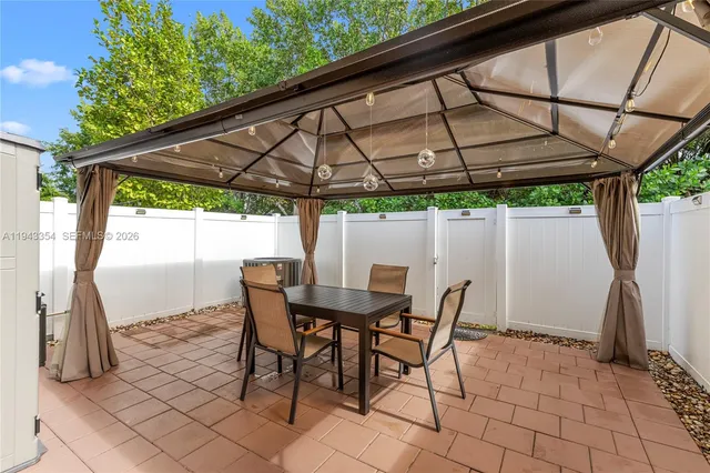 a patio with a patio table and chairs