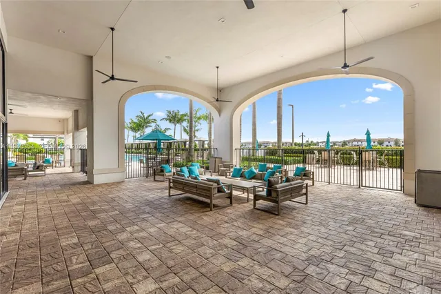a living room with couches a flat screen tv and outdoor view