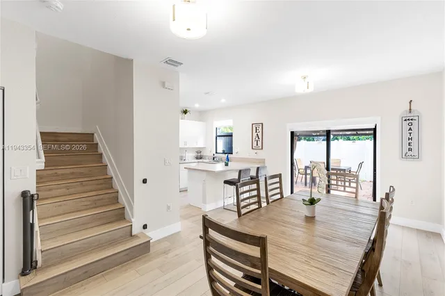 a view of a a dining room with furniture window and wooden floor