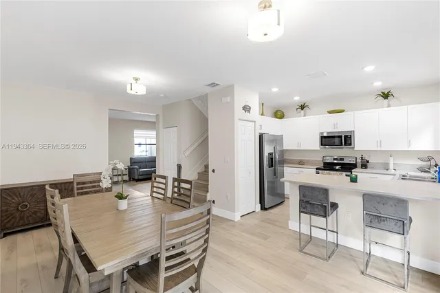 a large kitchen with a table and chairs in it