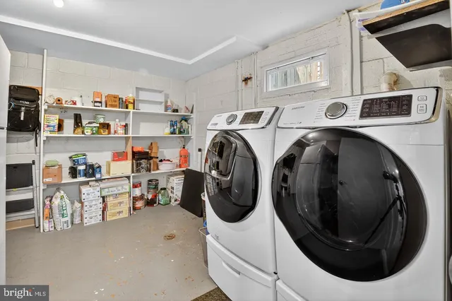 a utility room with sink dryer and washer