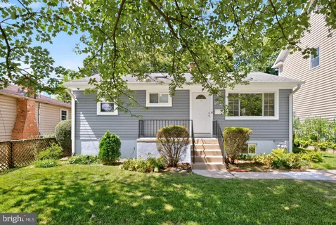 a view of a chair and table in backyard of the house