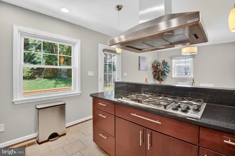 a kitchen with stainless steel appliances granite countertop a stove and a sink
