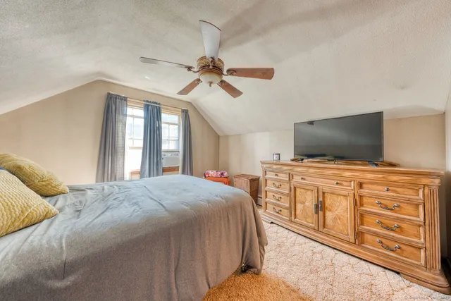 a bedroom with a bed and flat screen tv