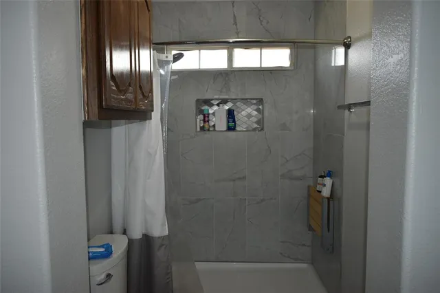 a bathroom with a shower and a mirror