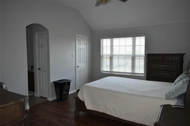 a bedroom with a bed and a window