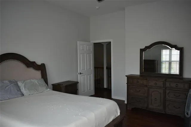 a bedroom with a bed and a bathroom with mirror