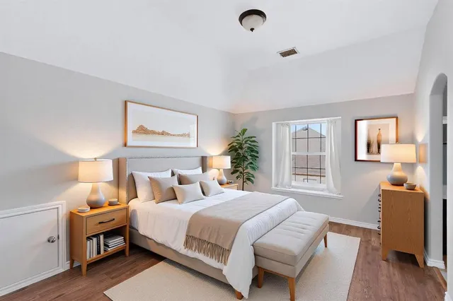 a living room with furniture a chandelier and a potted plant