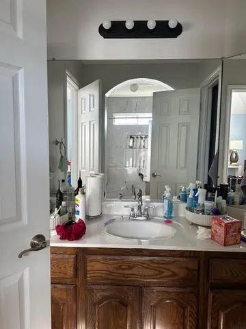 a bathroom with a sink vanity and a mirror
