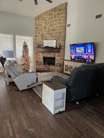 a living room with furniture and a fireplace