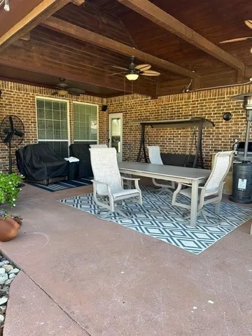 a building outdoor space with patio furniture and potted plants