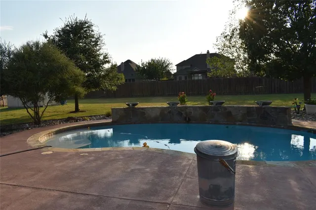 a view of a swimming pool with a yard