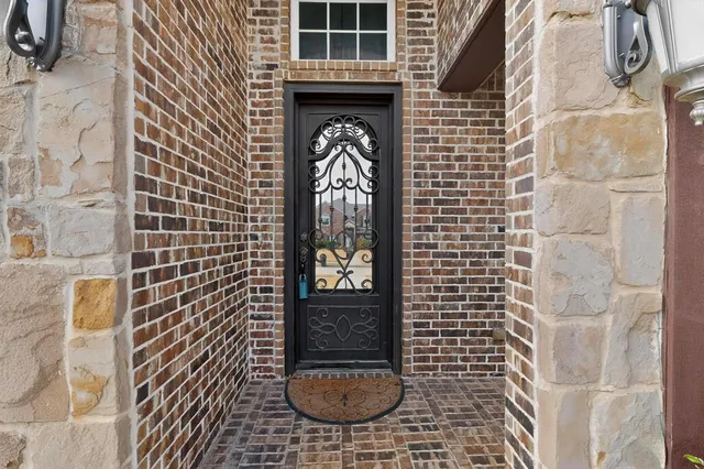 an empty room with wooden floor cabinet and windows