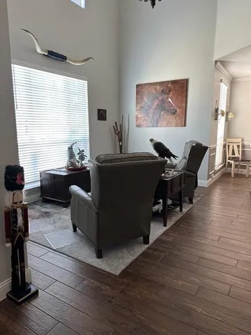a living room with furniture window and wooden floor