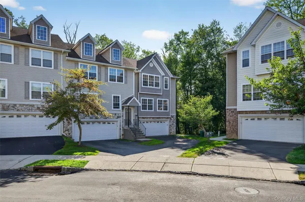 a front view of a house with a yard and a garage