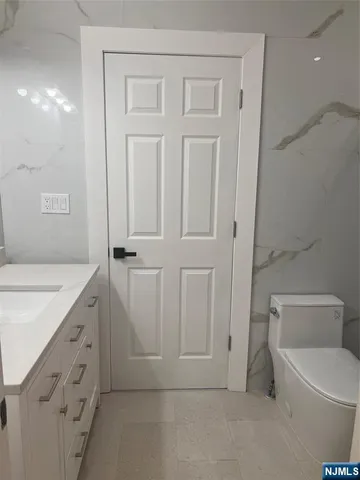 an entryway with wooden floor and cabinet