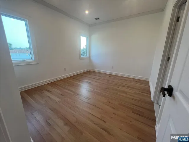 a view of hallway with wooden floor