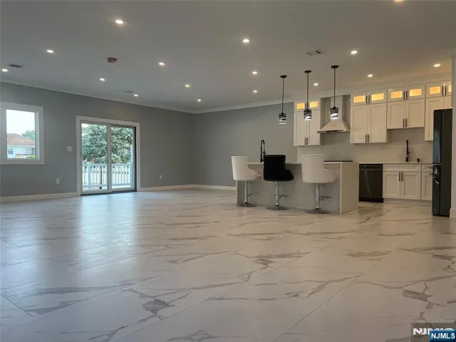 a view of kitchen with windows and refrigerator