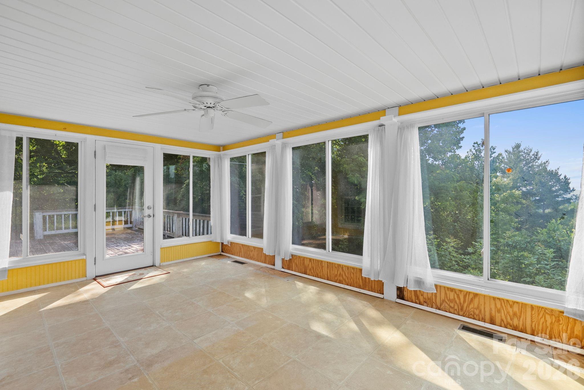 133 Spivey Mountain Road Asheville, NC 28806 - Photo 17 of 40 a view of an empty room with a fireplace and a large window