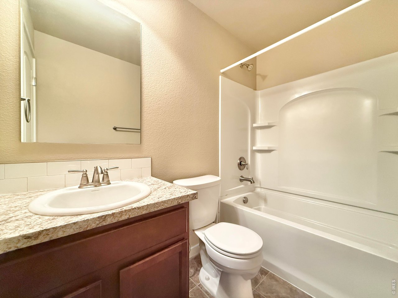 640 Cimarron Trail Ault, CO 80610 - Photo 12 of 15 a bathroom with a granite countertop sink toilet and shower